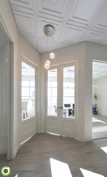 commercial renovation features vinyl plank flooring and suspended ceilings