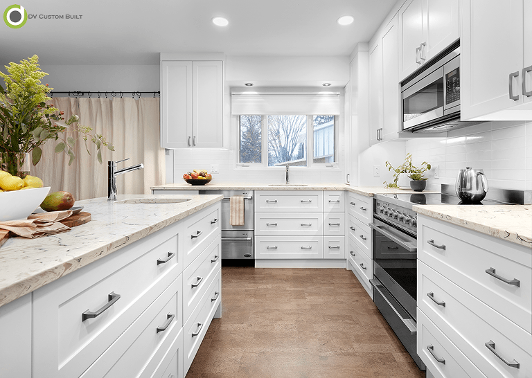 White kitchen cabinets, cork flooring and quartz countertops
